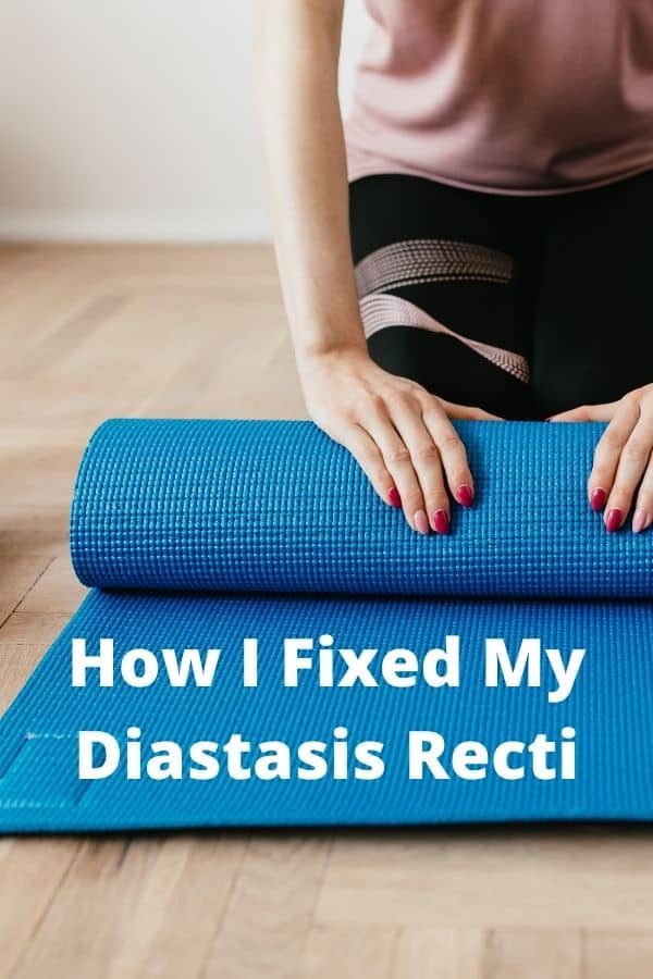 A woman kneeling on a wood floor infront of a blue yoga mat.  How I fixed my diastasis recti.  Mommy Maker Teacher. 