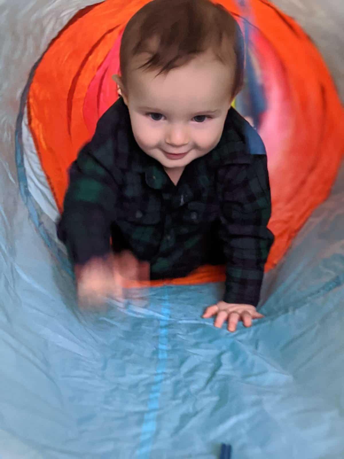baby crawling in tunnel