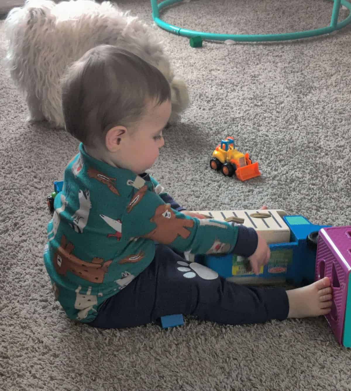 baby playing with melissa and doug shape sorting truck