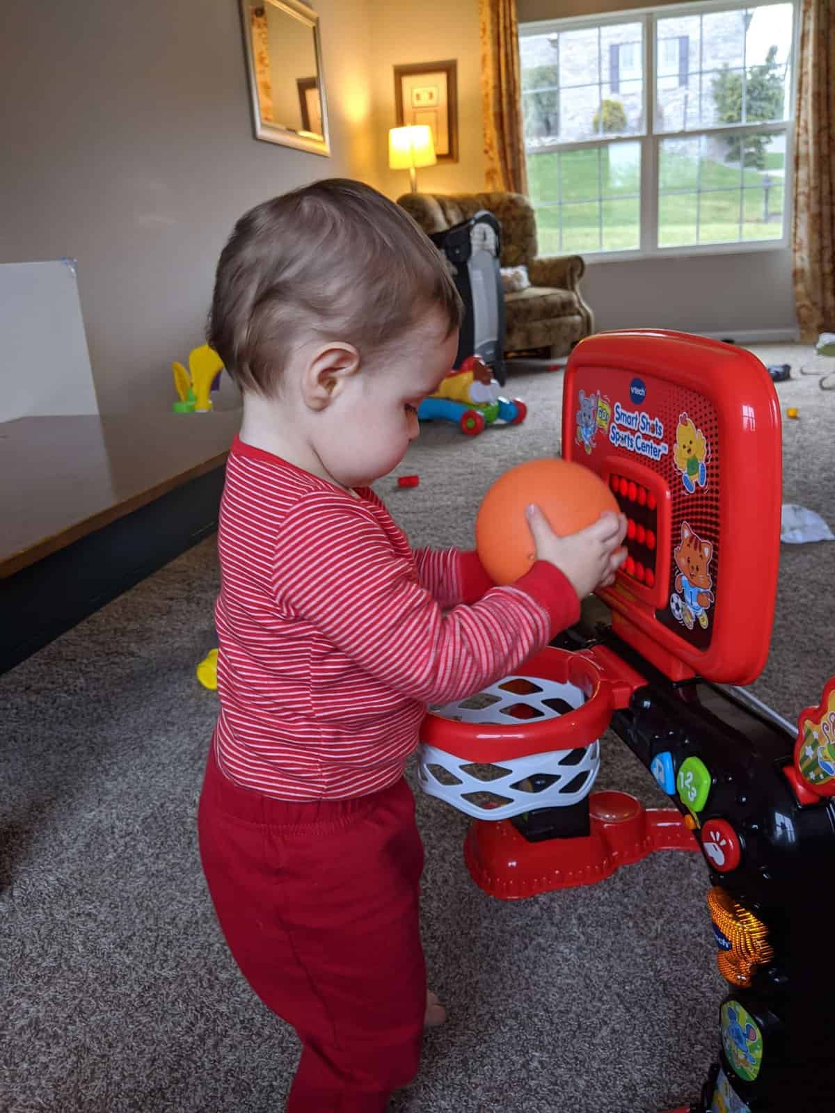 baby playing with vtech smart sports sports center