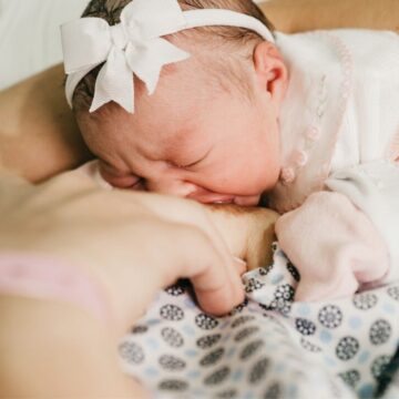 woman breastfeeding in a labor and delivery hospital gown