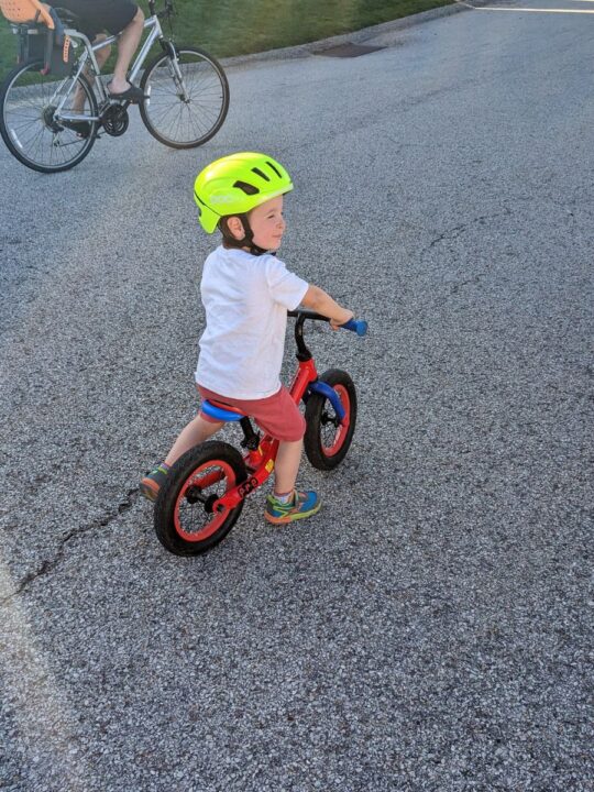 Toddler boy riding balance bike