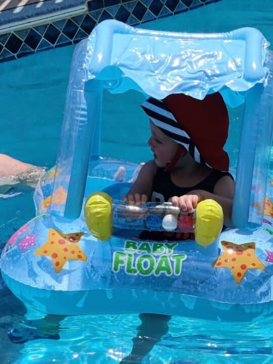 Toddler boy floating in Intex pool float