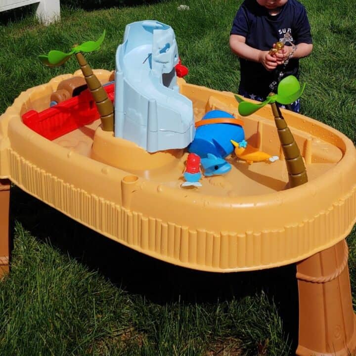 Toddler playing with Little Tikes water table