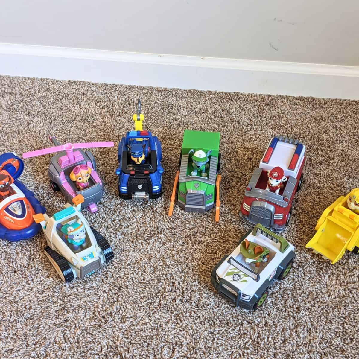 Lineup of Paw Patrol action figures and vehicles.